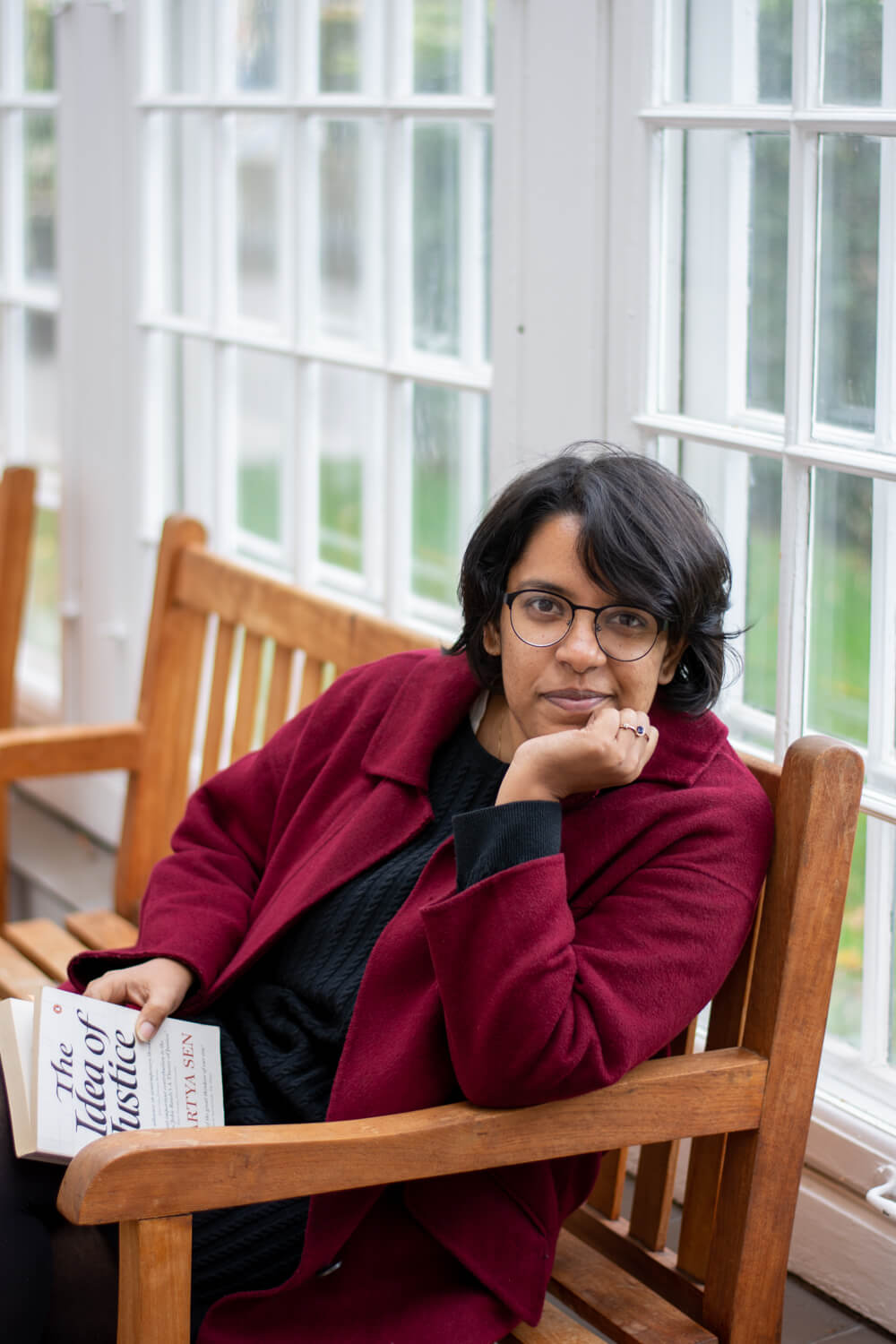 Suchismita Goswami sitting in a bench with a book on her hand