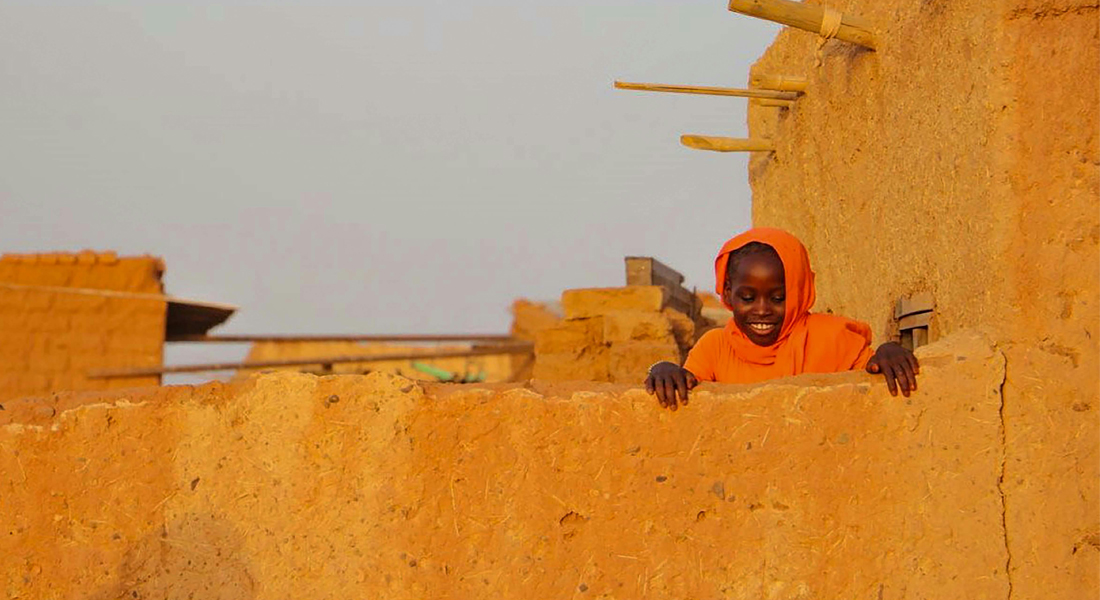 Girl is sand fortifications in Sudan